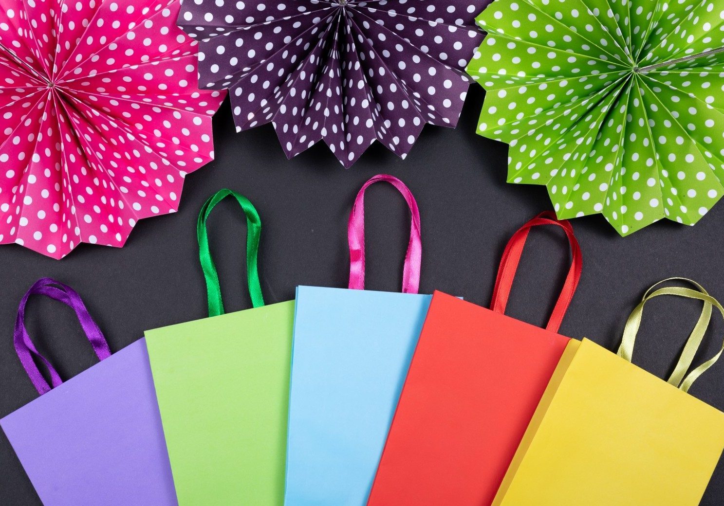 pink green and yellow paper bags